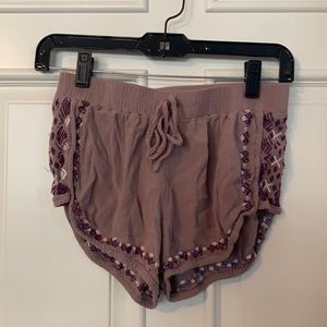 Mauve shorts with tribal print on the sides
